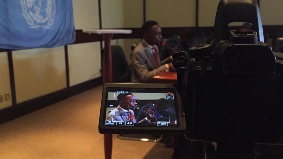 A camera records the Model UN committee.