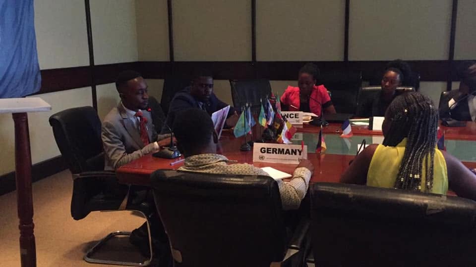 Germany and France confer across the corner of the council table.
