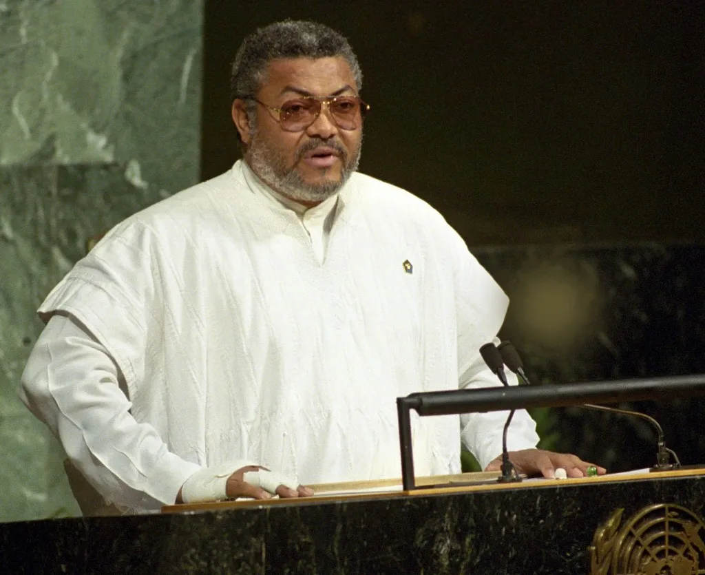 Jerry John Rawlings, in a white smock, speaking at the United Nations rostrum